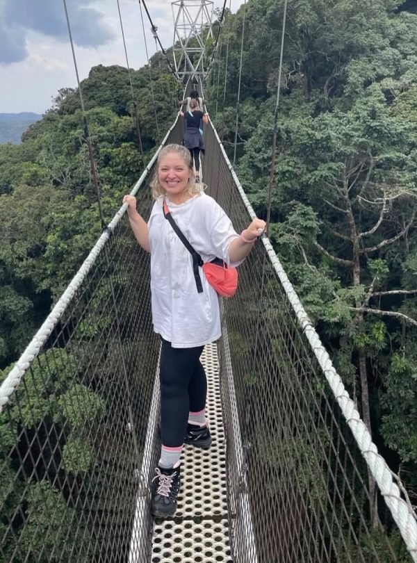 Traveler walking on the Nyungwe Canopy Walk in Rwanda