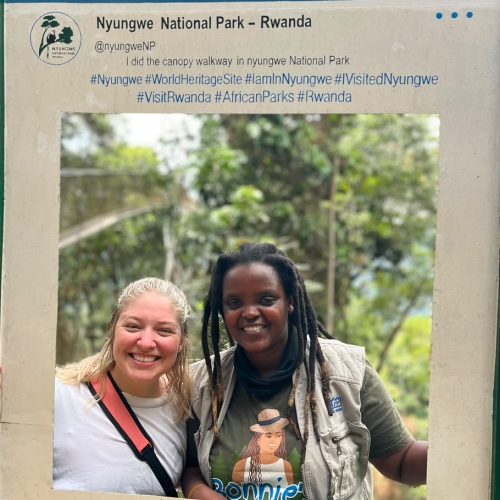 Traveler and guide at Nyungwe National Park Facebook sign in Rwanda